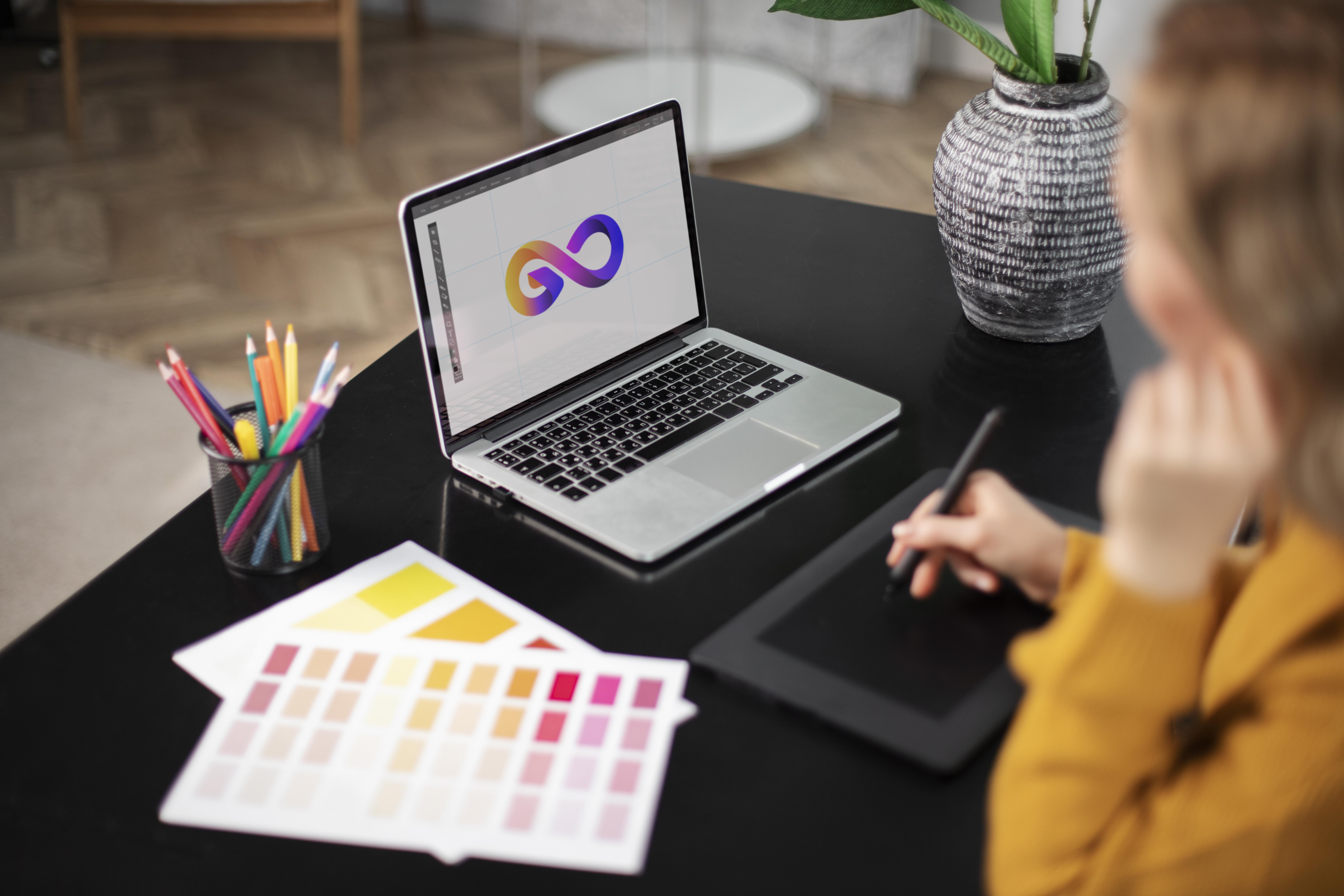 female-logo-designer-working-her-tablet-connected-laptop people, girls, women